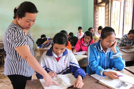 Cô giáo Bùi Thị Thanh Tuyền hướng dẫn em Tho trong giờ học. 